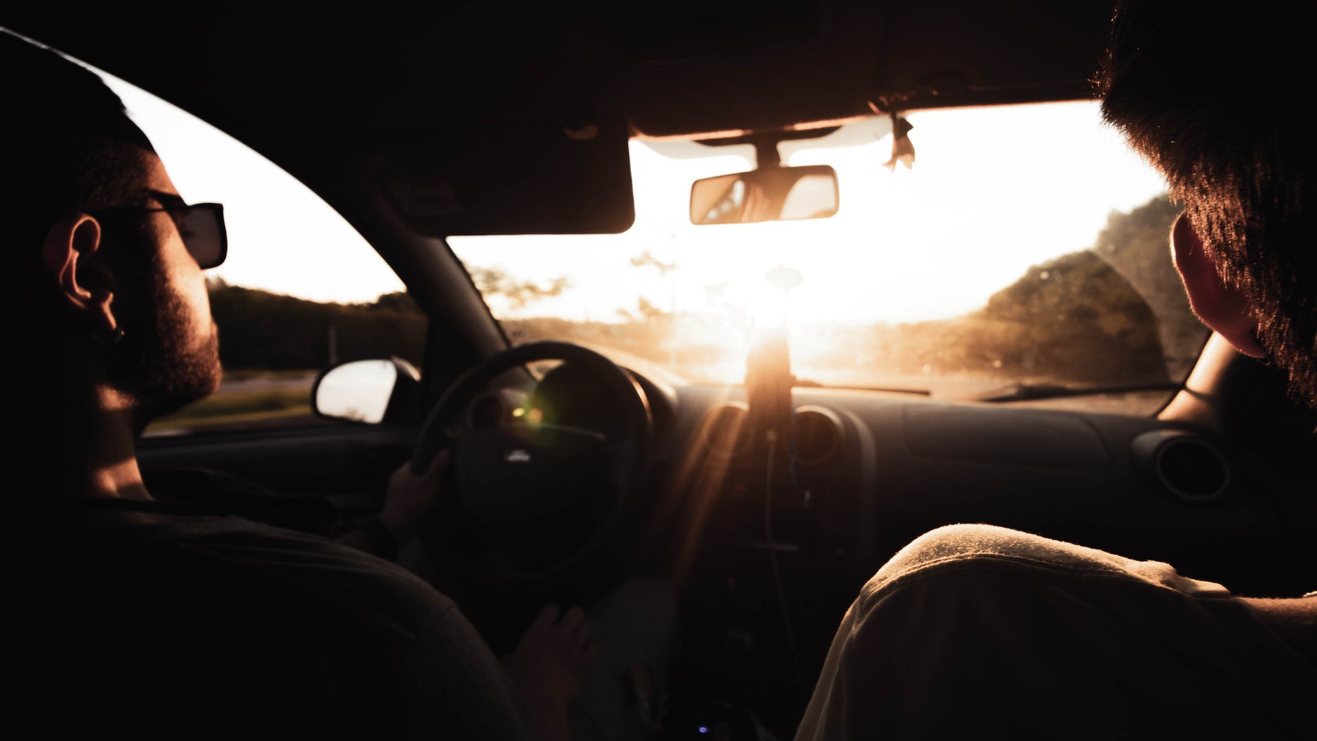 Two men driving into the sunset, counseling for men in Katy, Texas